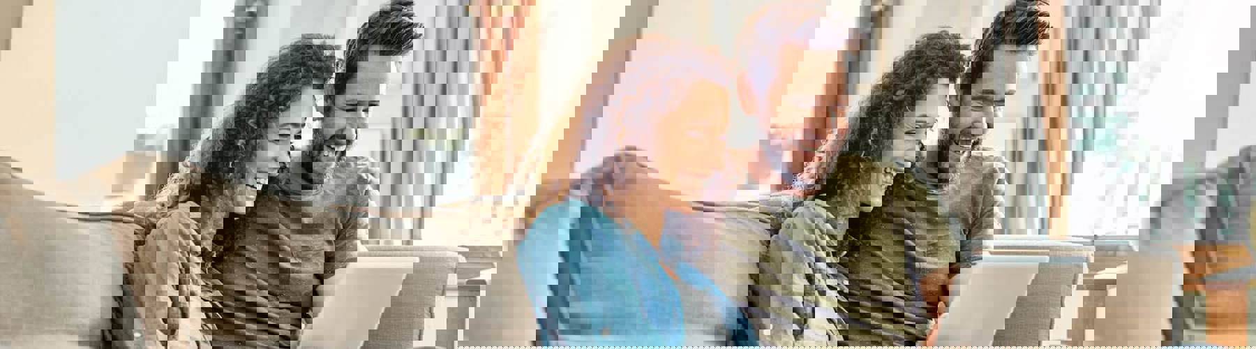 Couple on couch with tablet